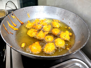 Indian dish Photo of deep frying Methi gota in oil in aluminum kadhai, PAKORA, ALOO BHAJIYA, gram flour fritter