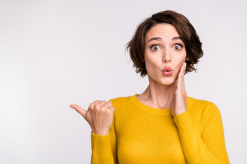 Photo of excited promoter girl direct thumb empty space wear yellow shirt isolated grey color background