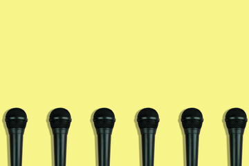 black microphones pattern on yellow background