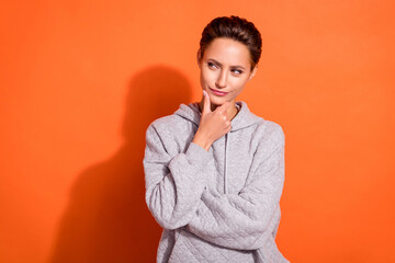 Photo of adorable uncertain young lady wear grey sweatshirt arm chin looking empty space isolated...