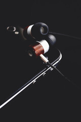 A modern audio player with headphones on a black background.