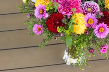 Autumn bouquet or composition of flowers of dahlias, New England asters, red, purple and yellow shades or warm tones. 
