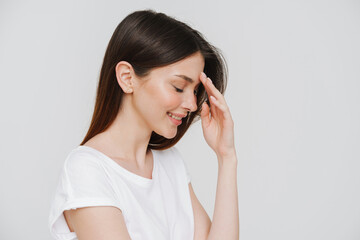 Fototapeta premium Young brunette woman in t-shirt smiling with her eyes closed