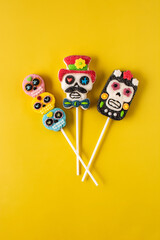 Candy skull lollipops isolated on yellow background