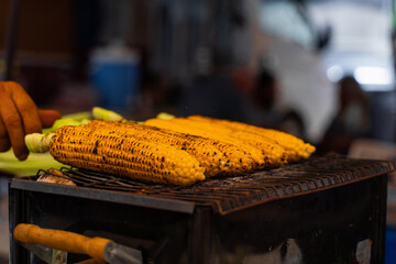 Fried corn on the grill on street. Healthy street food in Turkish market.