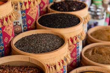 Assortment of Turkish spices and herbs in wooden bowls. Turkish market spices such as saffron, sumac and thyme. Cumin, rosemary and isot.