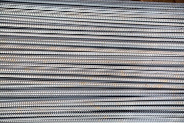 Metal corrugated reinforcement stacked in a gray color. Construction design, production backgrounds.