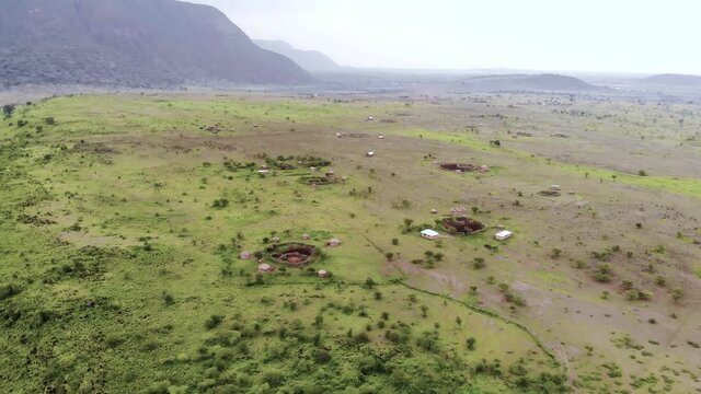 aerial approaching drone shot traditional masai village at sunset time near arusha tanzania