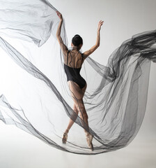 Portrait of young adorable Japanese ballerina dancing with transparent fabric, black cobweb...
