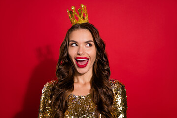 Photo of young impressed lady look empty space wear crown gold dress isolated on red background