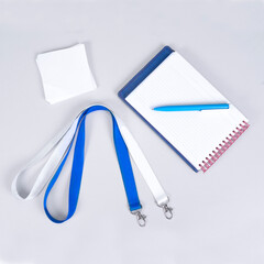 Composition of different promo products pen, notebook paper, lanyards neck strap, note paper. on...
