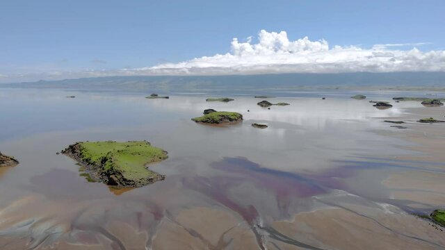 aerial flyby view on the islands at lake natron in the great rift valley between kenya and tanzania in the dry season the lake is 80 covered by soda and is known for its wading birds and huge