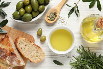 Flat lay composition with olive oil on white wooden table, flat lay