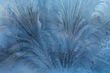 Frosty pattern frost on glass close-up. Horizontal photo.