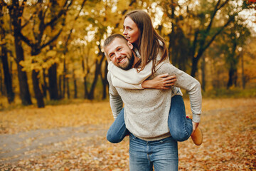 Elegant couple spend time in a autumn park