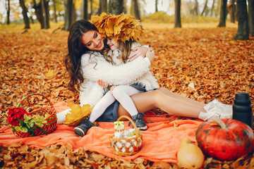 Cute and stylish family in a autumn park