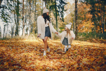 Fototapeta premium Cute and stylish family in a autumn park