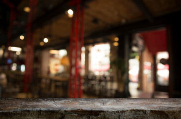 Naklejka na ściany i meble Empty dark wooden table in front of abstract blurred bokeh background of restaurant . can be used for display or montage your products.Mock up for space