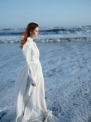 Fototapeta na wymiar Woman in white dress beach travel vacation landscape