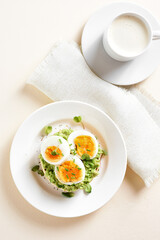 Avocado egg sandwich and cup of coffee