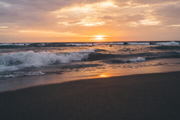 Fototapeta na wymiar Breathtaking view of sunset over waving ocean