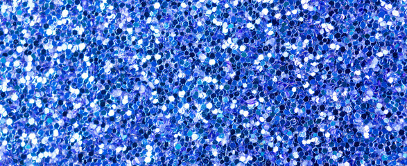Blue glitter texture, banner macro photo, high detailed surface. Close-up to sandpapper, abstract glitter lights for holiday celebration, new year and christmas. Glowing effect concept