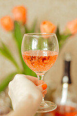 hand holding glass of red wine