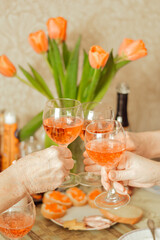 hands holding glass of red wine 