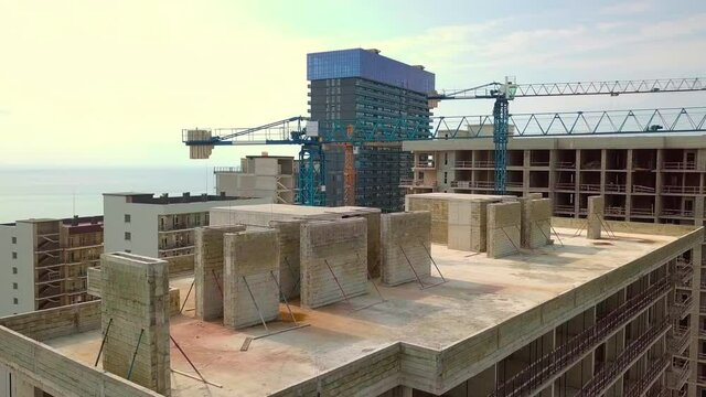 Construction of multi-storey residential building. Aerial photography. Batumi, Georgia. An apartment building on background of black sea in tourist city on coastline. Investment in real estate.