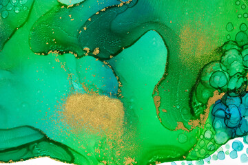 Abstract watercolor ink green and blue texture with gold glitter.