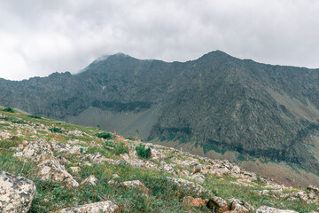 Fototapeta na wymiar View of the rocky ridge against the backdrop of a cloudy sky