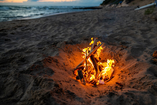 Fire burning in the sand on a beach