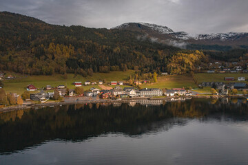 Small Town on the Shores of a Fjord in Norway Reflected in the Waters