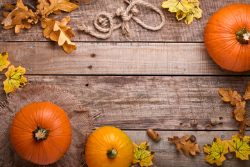 Pumpkin. Autumn food background with cinnamon, nuts and seasonal spices on rustic background. Cooking pumpkin or apple pie and cookies for Thanksgiving and autumn holidays. Top view with copy space.
