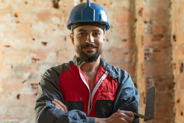Bricklayer poses smiling while renovating a bathroom