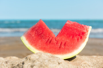 Slice of watermelon on a summer beach