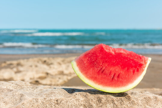 Slice of watermelon on a summer beach