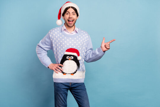 Photo of young happy positive man good mood point finger empty space xmas smile isolated on blue color background
