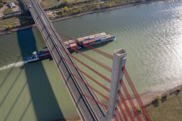 A Bridge Spanning a River with a Container Ship Moving Cargo