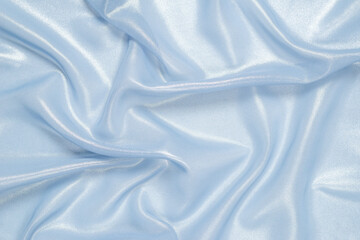 Blue shiny pearl fabric as a background.