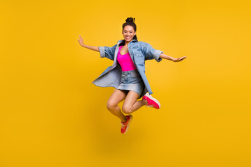 Full body photo of young black girl happy positive smile jump up air isolated over yellow color background