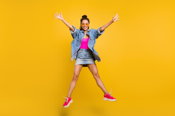 Fototapeta na wymiar Full size photo of young excited black girl happy positive smile have fun jump fly isolated over yellow color background