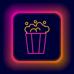 Glowing neon line Popcorn in cardboard box icon isolated on black background. Popcorn bucket box. Colorful outline concept. Vector
