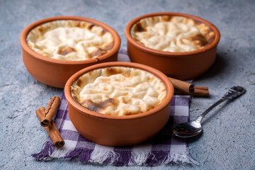 Baked rice pudding turkish milky dessert sutlac in earthenware casserole with hazelnuts