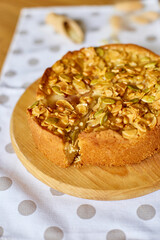 Apple or pear pie, tart with caramel nuts on wooden table, copy space, top view.