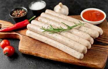 raw bavarian sausages on a stone background