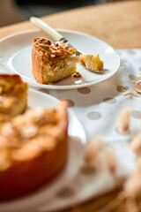 Piece of apple or pear pie, tart with caramel nuts on wooden table, copy space, top view.