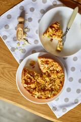 Piece of apple or pear pie, tart with caramel nuts on wooden table, copy space, top view.