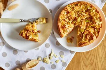 Piece of apple or pear pie, tart with caramel nuts on wooden table, copy space, top view.