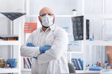 Confident nurse in front of medical team looking at camera wearing a face mask during a covid-19